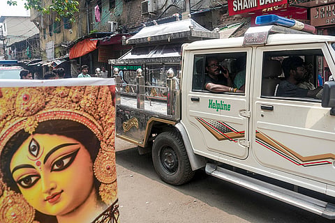 Mortal remains of a victim of the stampede at Chorbagan Sarbojanin Durga Puja pandal being taken in a dead body carrier vehicle, in Kolkata. Nineteen people died, and 25 others were injured in the stampede following a crowd surge amid rain on Saturday evening.