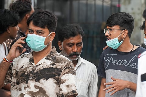 Relatives of victims killed in a stampede at the Chorbagan Durga Puja pandal gather outside a mortuary, in Kolkata, Sunday, Oct. 18, 2026. At least 19 people were killed and 25 others injured in the incident.
