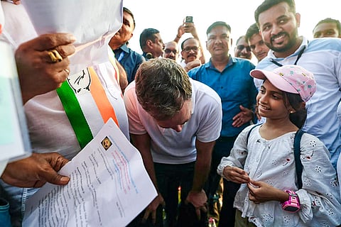In this image received on Oct. 18, 2026, Leader of Opposition in the Lok Sabha Rahul Gandhi interacts with a child during 'Goy Rakhonn Yatra', in Margao, Goa.