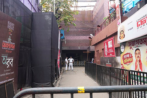 Police personnel deployed at Chorbagan Sarbojanin Durga Puja pandal following a stampede, in Kolkata. Nineteen people died and 25 others were injured in the stampede following a crowd surge amid rain on Saturday evening.