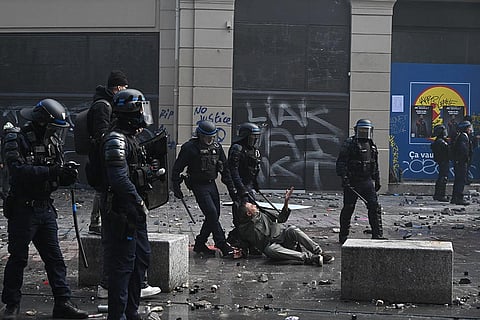 Police detain a protester during a demonstration against rising living costs and students' grievances, in Paris, Saturday, Oct. 17, 2026.