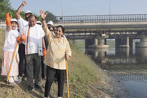 In this image posted on Oct. 18, 2026, Delhi CM Rekha Gupta during the cleanliness drive at Hathi Ghat under the ‘Chalo Yamuna Abhiyan’, in New Delhi.