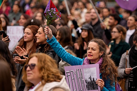 People shout slogans during a protest aiming to raise awareness to the violence and prejudice against women in Romanian society, in Bucharest, Romania, Saturday, Oct. 17, 2026.