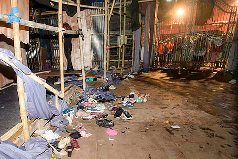 Footwear lies scattered outside a Durga Puja pandal after the exit gate collapsed due to heavy crowd pressure, leading to a stampede-like situation, in Kolkata, Saturday, Oct. 17, 2026. 