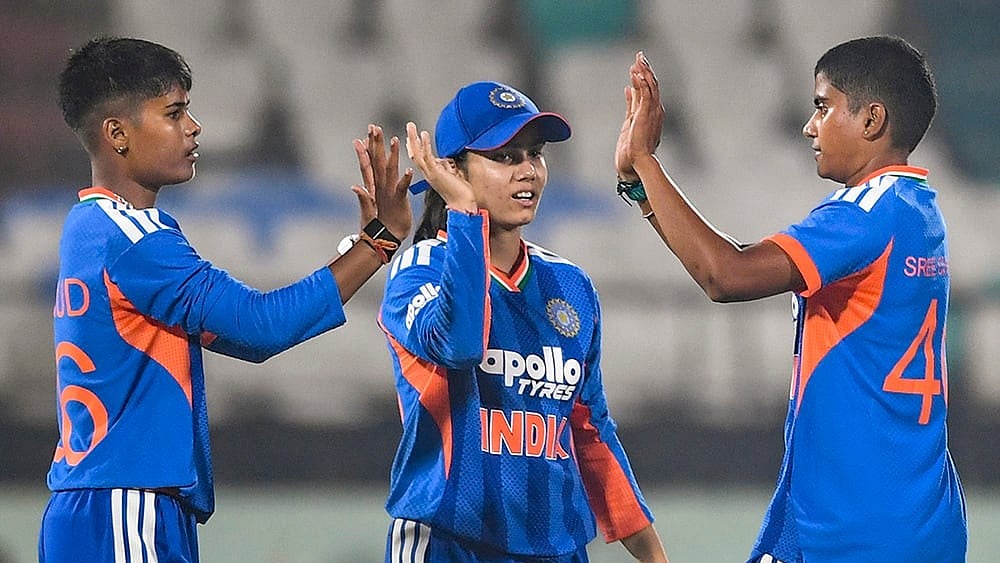India's Kranti Gaud, left, with teammates Vaishnavi Sharma, center, and Shree Charani during the first Women's T20I cricket match between India and Sri Lanka, in Visakhapatnam, Andhra Pradesh. - | Photo: PTI