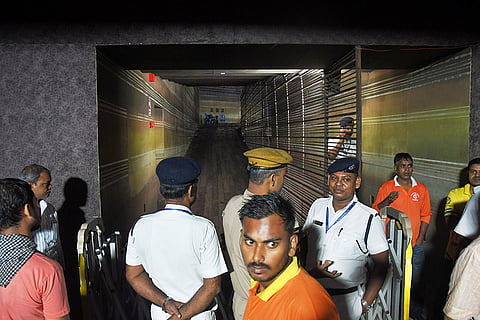 Police officers stand guard at the closed entrance to a worship venue for the Hindu festival of Durga Puja following a stampede, in Kolkata, India.