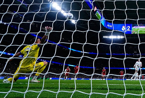 Real Madrid's Kylian Mbappe scores from a penalty kick during the La Liga soccer match between Real Madrid and Sevilla in Madrid, Spain, Sunday, Oct. 18, 2026. 