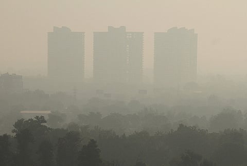 High-rise buildings remain shrouded amid hazy conditions, in Gurugram.