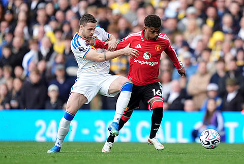 Manchester United's Amad Diallo, right, and Leeds United's Gabriel Gudmundsson battle for the ball during the English Premier League soccer match between Leeds United and Manchester United in Leeds, England, Sunday, Oct. 18, 2026.
