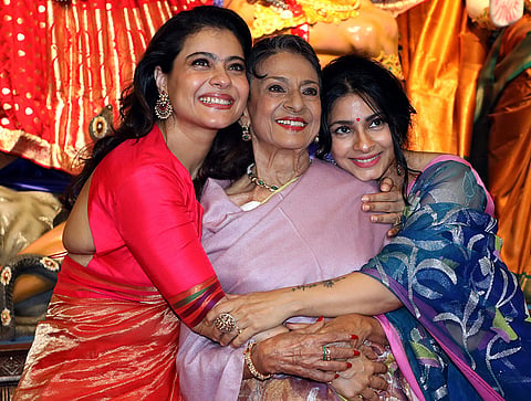 From left, Bollywood actors Kajol, Tanuja Samarth, Tanishaa Mukerji pose for photographs during the 80th North Bombay Durga Puja festival, in Mumbai, Thursday, Oct. 15, 2026. 

