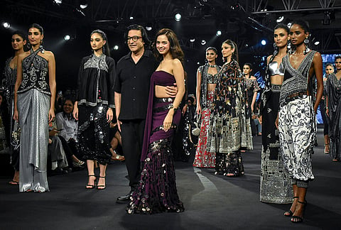 Designer Suneet Varma and showstopper actor Nitanshi Goel pose with models during the Lakme Fashion Week x FDCI, in New Delhi, Thursday, Oct. 15, 2026. 
