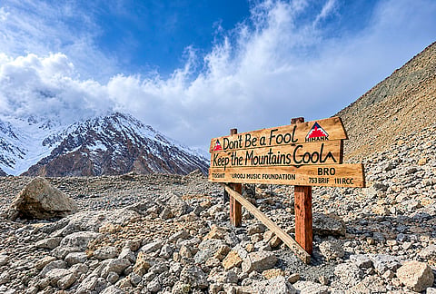 A hand painted signboard installed by Urooj Music Foundation team after completing a cleanup drive, in Ladakh. 
