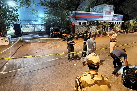Police and forensic officials conduct investigation at the crime scene where gunmen opened fire at Bollywood actor Tiger Shroff, near Pushpa Park under Juhu police station, in Mumbai, Maharashtra, Sunday, Oct. 18, 2026. The actor escaped unhurt while his driver and another driver of an autorickshaw were injured in the incident, police said.