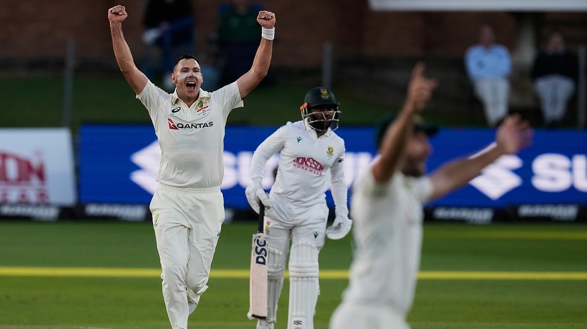 Australia's Scott Boland, left, celebrates the wicket of South Africa's Ryan Rickelton on day two of the second cricket test match between South Africa and Australia, in Gqeberha, South Africa, Monday, Oct. 19, 2026 - (AP Photo/Themba Hadebe)