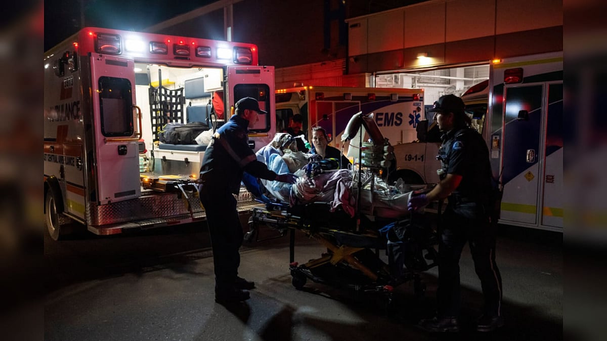 Paramedics load an injured person into an ambulance at the Wainwright Health center after a fire at Canadian Forces Base Wainwright - John Ulan/The Canadian Press via AP