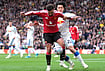 | Photo: Annabel Lee-Ellis/PA via AP : Manchester United's Bruno Fernandes, left, and Leeds United's Ao Tanaka battle for the ball during the English Premier League soccer match between Leeds United and Manchester United in Leeds, England, Sunday, Oct. 18, 2026. 