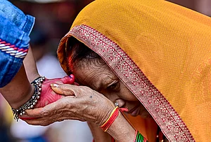 | Photo: PTI : A woman seeks blessings of a young girl during 'Kanya Pujan' rituals on of Maha Navami, as part of the Navratri festival, in Prayagraj.