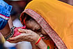 | Photo: PTI  : A woman seeks blessings of a young girl during 'Kanya Pujan' rituals on of Maha Navami, as part of the Navratri festival, in Prayagraj.

