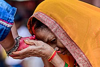 | Photo: PTI  : A woman seeks blessings of a young girl during 'Kanya Pujan' rituals on of Maha Navami, as part of the Navratri festival, in Prayagraj.
