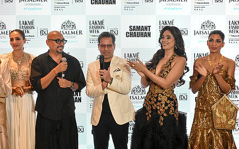 Designer Samant Chauhan, second left, with actor Pavleen Gujral, second right, and others during the Lakme Fashion Week x FDCI, in New Delhi, Thursday, Oct. 15, 2026. 
