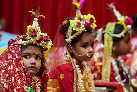 Young girls dressed as Goddess Durga during 'Kumari Puja' as part of Durga Puja festival celebrations, in Kolkata.
