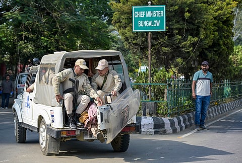 Police personnel transport the bodies of two victims, who were allegedly killed in an ambush by armed miscreants while collecting firewood at Sunurok Uyok in Imphal East district, away from outside the Chief Minister’s bungalow towards a hospital mortuary, in Imphal.
