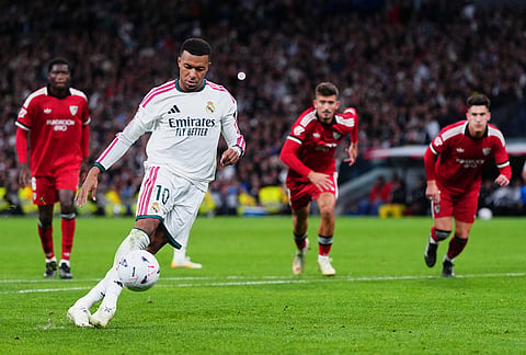 Real Madrid's Kylian Mbappe scores from the penalty kick during the La Liga soccer match between Real Madrid and Sevilla in Madrid, Spain, Sunday, Oct. 18, 2026. 