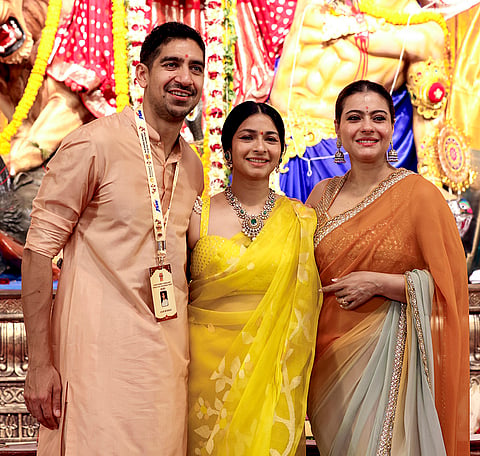 (L-R) Filmmaker Ayan Mukerji, actress Tanishaa Mukerji, and Bollywood actress Kajol pose for photographs during the 80th North Bombay Sarbojanin Durga Puja celebrations, in Mumbai, Saturday, Oct. 17, 2026. 
