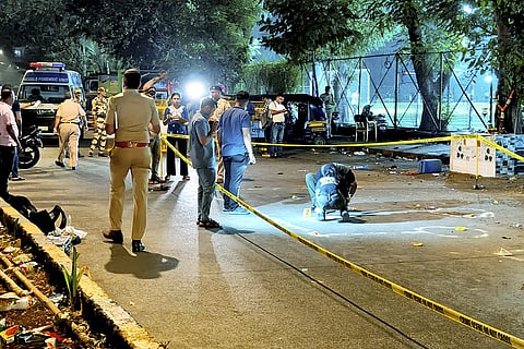 Police and forensic officials conduct investigation at the crime scene where gunmen opened fire at Bollywood actor Tiger Shroff, near Pushpa Park under Juhu police station, in Mumbai, Maharashtra, Sunday, Oct. 18, 2026. The actor escaped unhurt while his driver and another driver of an autorickshaw were injured in the incident, police said.