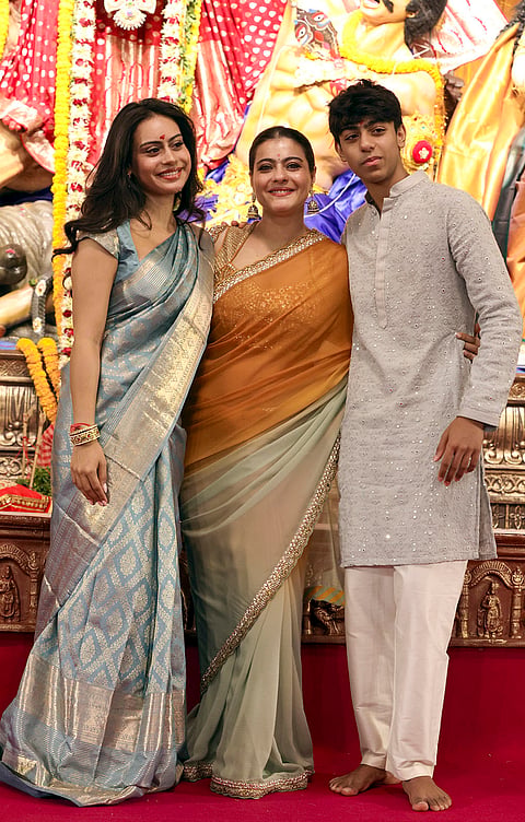 Bollywood actor Kajol with her son Yug Devgan and daughter Nysa Devgan during the 80th North Bombay Sarbojanin Durga Puja celebrations, in Mumbai, Saturday, Oct. 17, 2026. 

