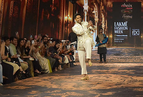 Cricketer Suryakumar Yadav walks the ramp during the Lakme Fashion Week (LFW), in New Delhi, Sunday, Oct. 18, 2026. 
