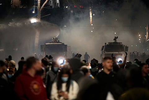 Police water cannons douse protesters during clashes at an anti-government demonstration in Tirana, Albania, Sunday, Oct. 18, 2026. 
