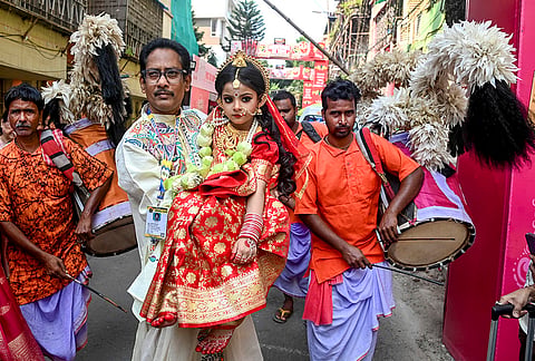 A young girl being carried during a procession before 'Kumari Puja' on the ninth day of the ongoing Durga Puja festival, in Kolkata, West Bengal.
