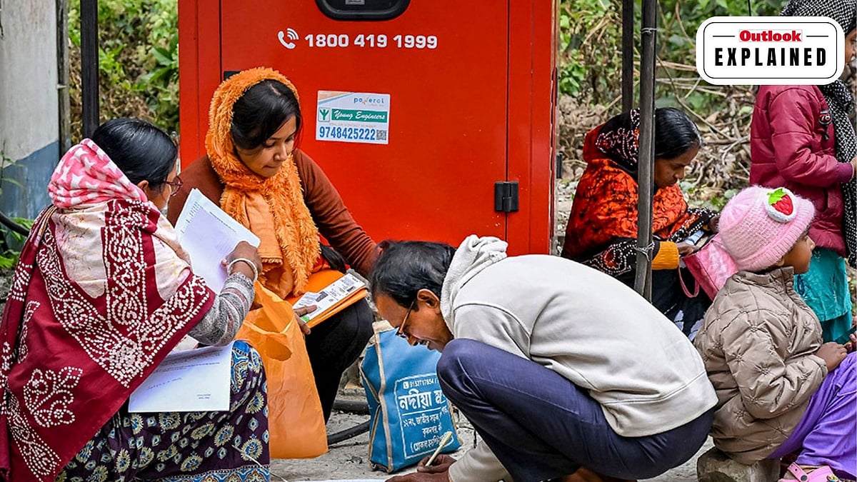 People arrange their documents during hearings under the Special Intensive Revision (SIR) of electoral rolls. - PTI 