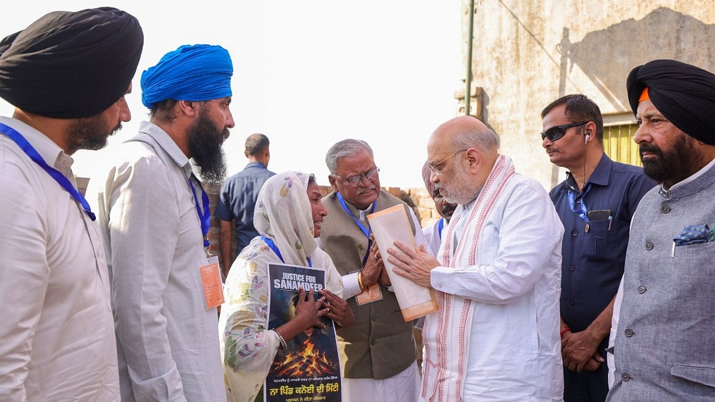 Union Minister Amit Shah with the family of Late Gulzar Singh  - X