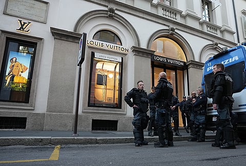 Police officers patrol as luxury shops remain closed at the Via Monte Napoleone street in Milan, Italy, a day after rioters clashed with police, looted stores and set property on fire, Monday, Oct. 19, 2026. 
