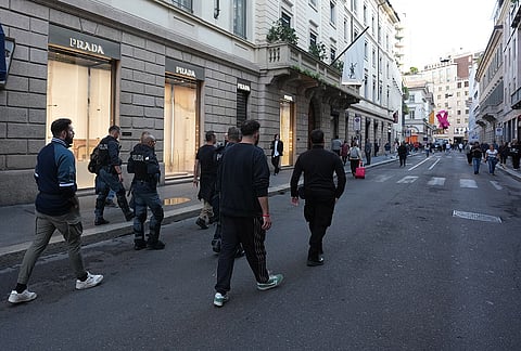 Police officers patrol as luxury shops remain closed at the Via Monte Napoleone street in Milan, Italy, a day after rioters clashed with police, looted stores and set property on fire, Monday, Oct. 19, 2026. 
