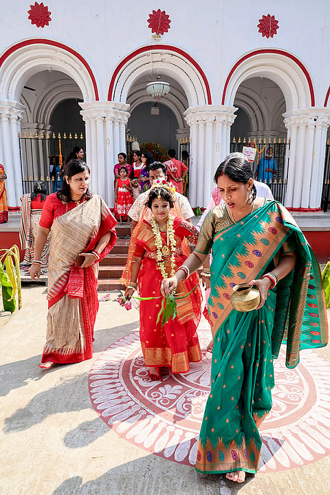 A girl dressed as 'Kumari', a human embodiment of Goddess Durga, takes part in a procession during ‘Kumari Puja’ on the ninth day of Durga Puja festival, at Raipur village, in Birbhum district, West Bengal.