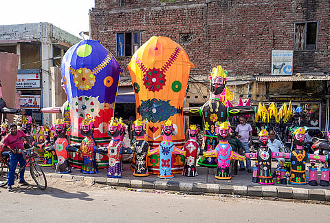 A man moves past effigies of demon king ‘Ravana’ on the eve of the ‘Dussehra’ festival, in Amritsar, Monday, Oct. 19, 2026. 
