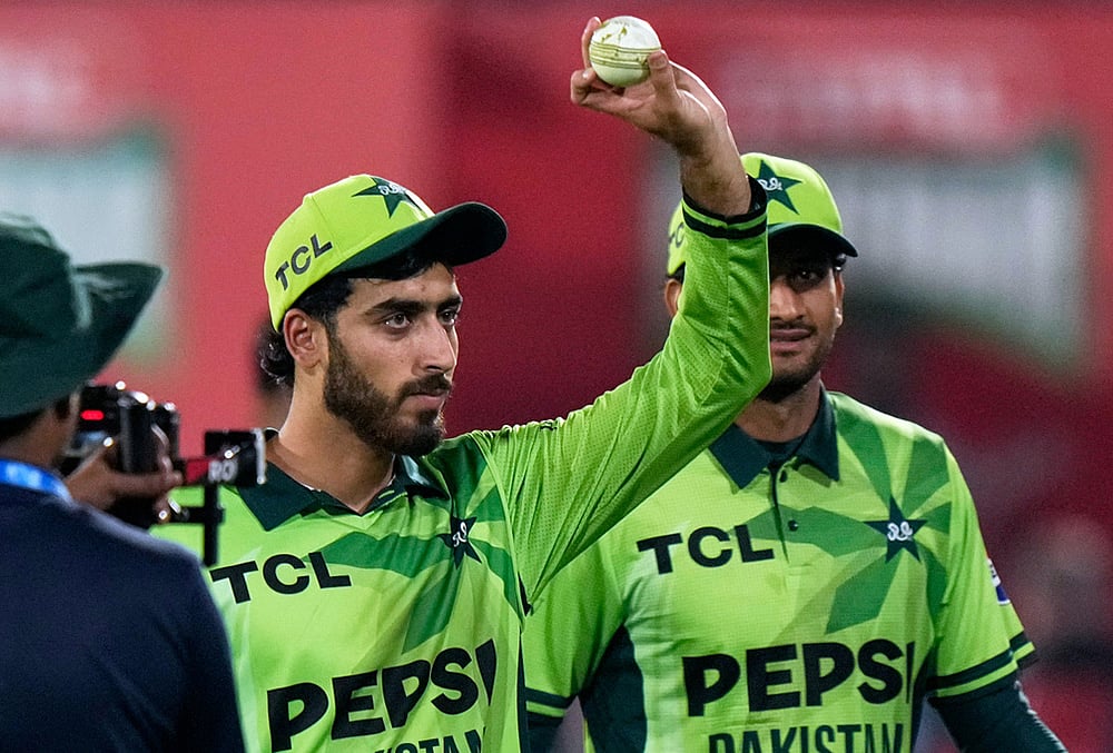 Pakistan's Arafat Minhas, who took the six wickets, displays the ball on the end of the tri-series one-day international cricket match between against England, in Rawalpindi, Pakistan, Tuesday, Oct. 20, 2026.  - | Photo: AP/Anjum Naveed