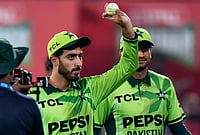 Arafat Minhas’ Six-Wicket Haul Powers Pakistan To 87-Run Win | Photo: AP/Anjum Naveed : Pakistan's Arafat Minhas, who took the six wickets, displays the ball on the end of the tri-series one-day international cricket match between against England, in Rawalpindi, Pakistan, Tuesday, Oct. 20, 2026.