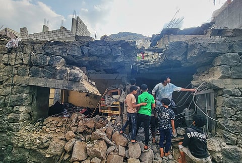 Residents walk amid debris from their homes after a missile strike in Seina, Taiz, Yemen, Tuesday, Oct. 20, 2026. 
