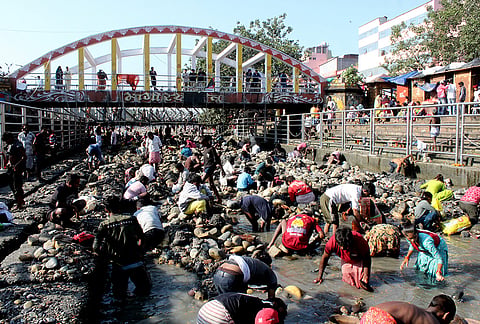 People gather amid reduced water flow at Har Ki Pauri as the Ganga Canal remains closed for maintenance work, in Haridwar, Uttarakhand,.
