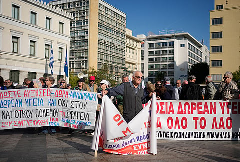 Thanassis Argyris, front, 82, a retired construction worker, attends a rally organized by pensioners' associations demanding pension increases and measures to address the rising cost of living in Athens, Greece, Wednesday, Oct. 21, 2026. 
