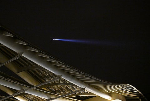 A helicopter patrols during an overnight curfew in Paris, Tuesday, Oct. 20, 2026. 
