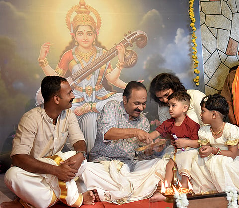 Keralam Chief Minister VD Satheesan with a child during the 'Vidyarambham' ceremony on the occasion of 'Vijayadashami', at his office in Paravur, Ernakulam district, Kochi, Keralam.
