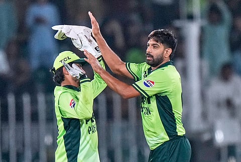 Pakistan's Haris Rauf, right, celebrates with teammate after taking the wicket of England's Ben Duckett during the tri-series one-day international cricket match between Pakistan and England, in Rawalpindi, Pakistan, Tuesday, Oct. 20, 2026. 