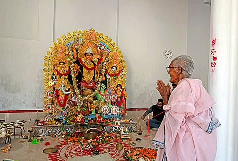An elderly woman offers prayers to Goddess Durga during 'Bijoya Dashami' on the final day of the Durga Puja festival, in Raipur village, Birbhum district, West Bengal, Wednesday, Oct. 21, 2026. 
