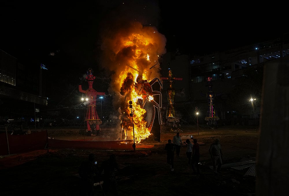 A cockroach effigy is set ablaze at Ramlila ground as part of Dussehra festival celebrations, in New Delhi.
 - | Photo: PTI/Arun Sharma