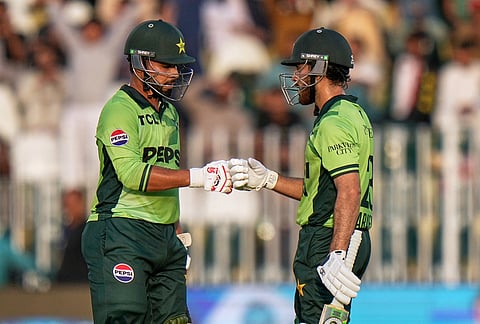 Pakistan's Arafat Minhas, right, celebrates with Faheem Ashraf after hitting a boundary during the tri-series one-day international cricket match between Pakistan and England, in Rawalpindi, Pakistan, Tuesday, Oct. 20, 2026. 